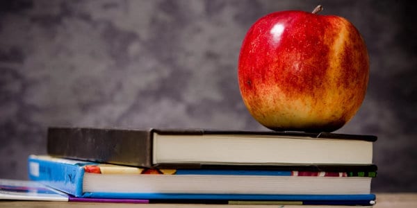 close-up of apple on top of books