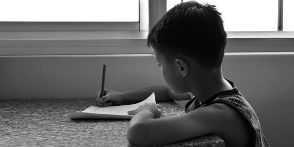 Young boy writing