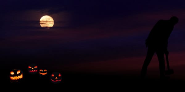 Silhouette of hunched man with mallet under harvest moon, walking away from jack-o-lantarns