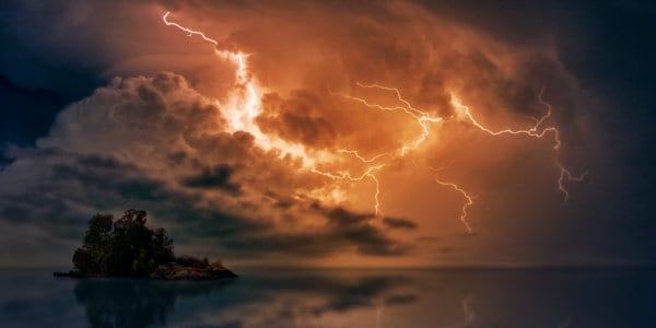 Lightning and storm clouds above lake.