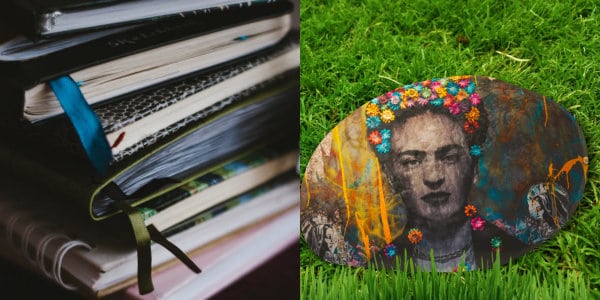 Stack of journals and a painted rock on grass.