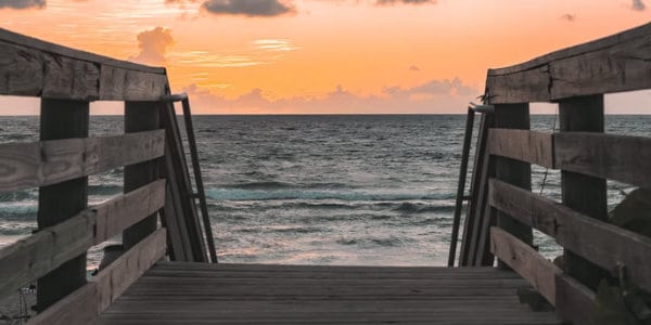 Walking bridge leading towards ocean.