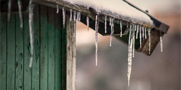 Icicles hanging of roof edge of shed.