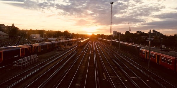 Train tracks with sun just above horizon