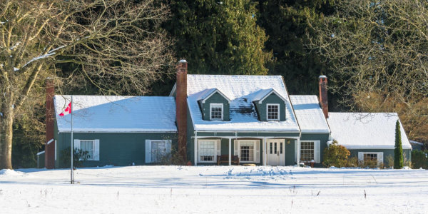 Canadian farmhouse in winter with snow