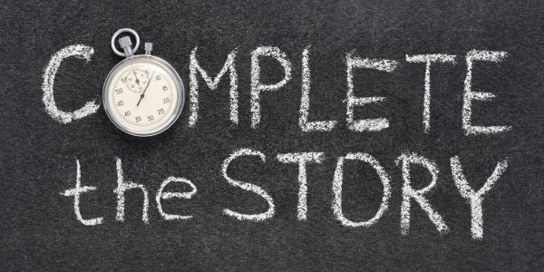 "Complete The Story" written on a blackboard, with a pocket watch beside it