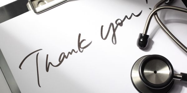 Clipboard with a stethoscope on it, and a note - saying "Thank You"