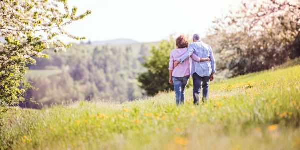 A happy couple walking on rolling hills in Springtime