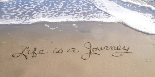 A beach with "Life is a journey" written in the sand